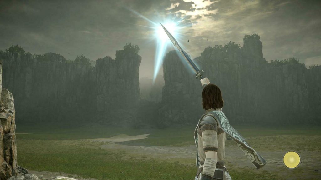Shadow of the Colossus: the protagonist raises a sword toward the light.