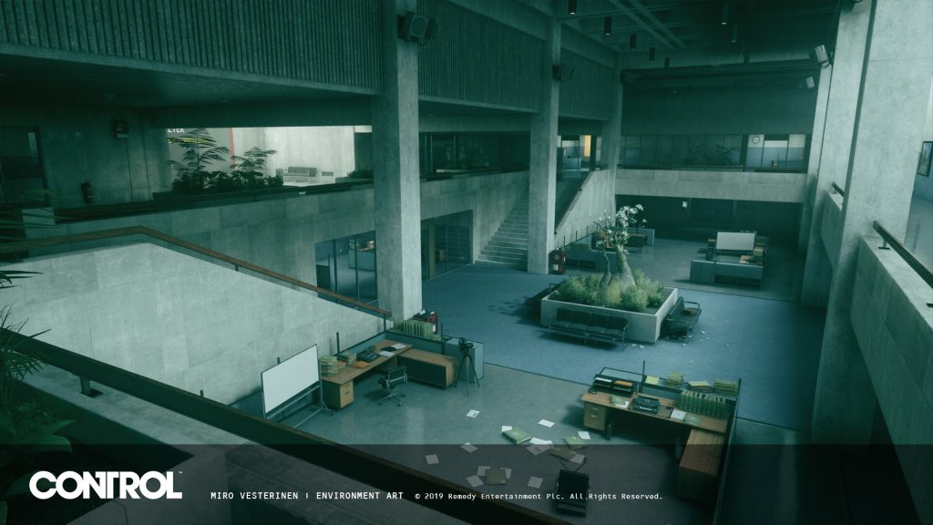 An office in Control beneath a large concrete structure.
