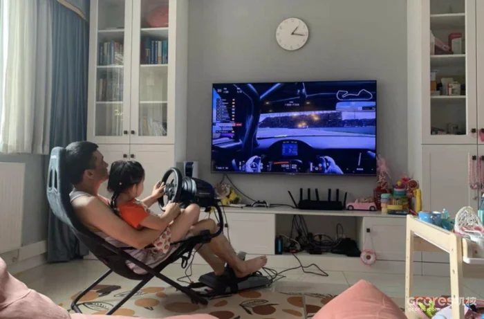 A parent and child playing a racing game together.